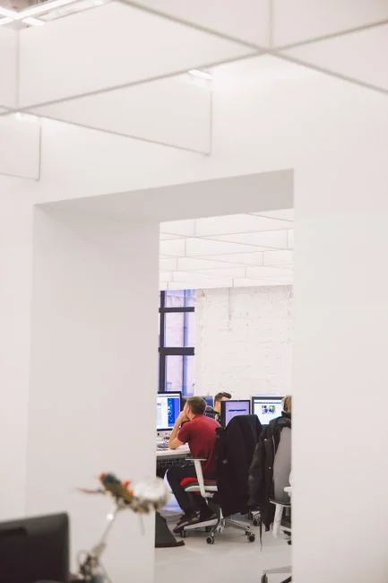 Un espace de travail moderne avec deux écrans d’ordinateur affichant des projets de web design, mettant en avant la technologie et la productivité.